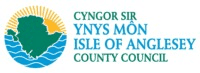 Logo of Isle of Anglesey County Council featuring a green map outline, blue waves, and sun rays, with Welsh and English council names in blue and green text.