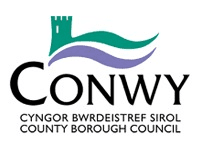 Conwy County Borough Council logo with a stylized green castle, purple and teal waves above the text in Welsh and English.